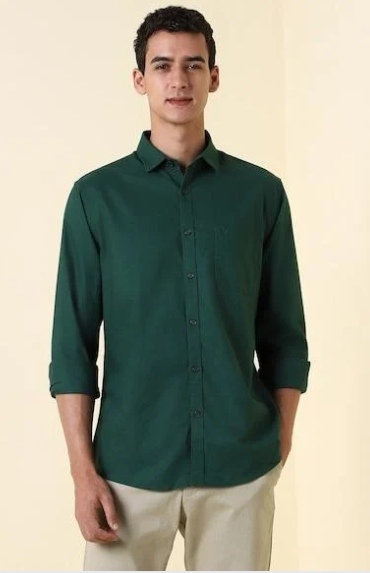Man wearing dark green casual shirt with beige trousers in clean background