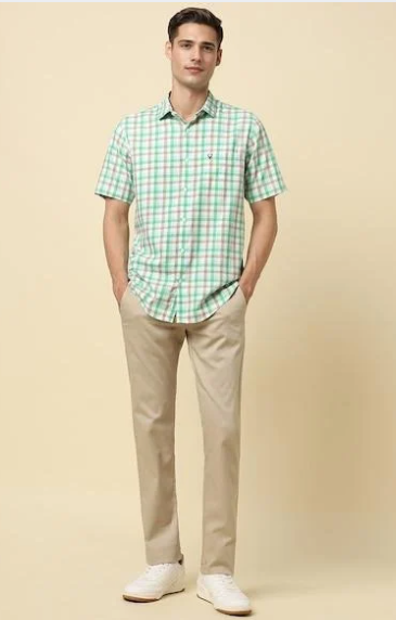 Man wearing green check casual shirt with beige trousers and sneakers