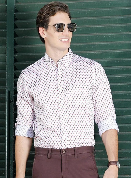 Man wearing printed casual shirt with rolled sleeves and sunglasses