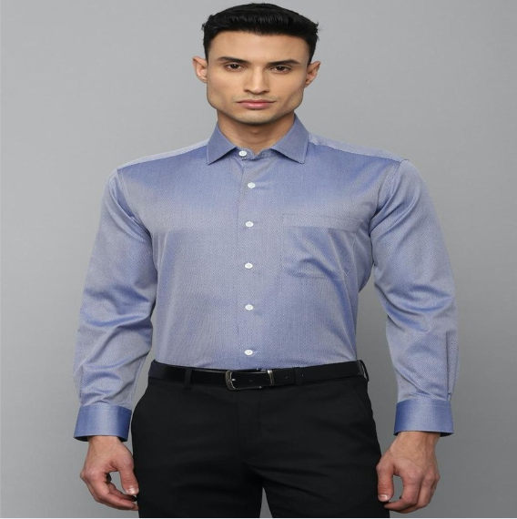 Man wearing light blue formal shirt with slim fit and black trousers