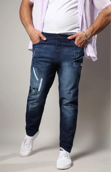 Man wearing blue denim jeans with casual white sneakers and hands in pockets
