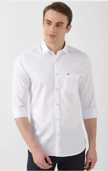 Man wearing white casual shirt with rolled sleeves in clean studio background