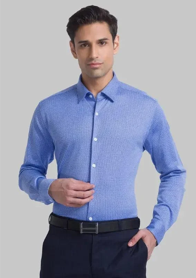 Man wearing light blue formal shirt with textured fabric and black trousers