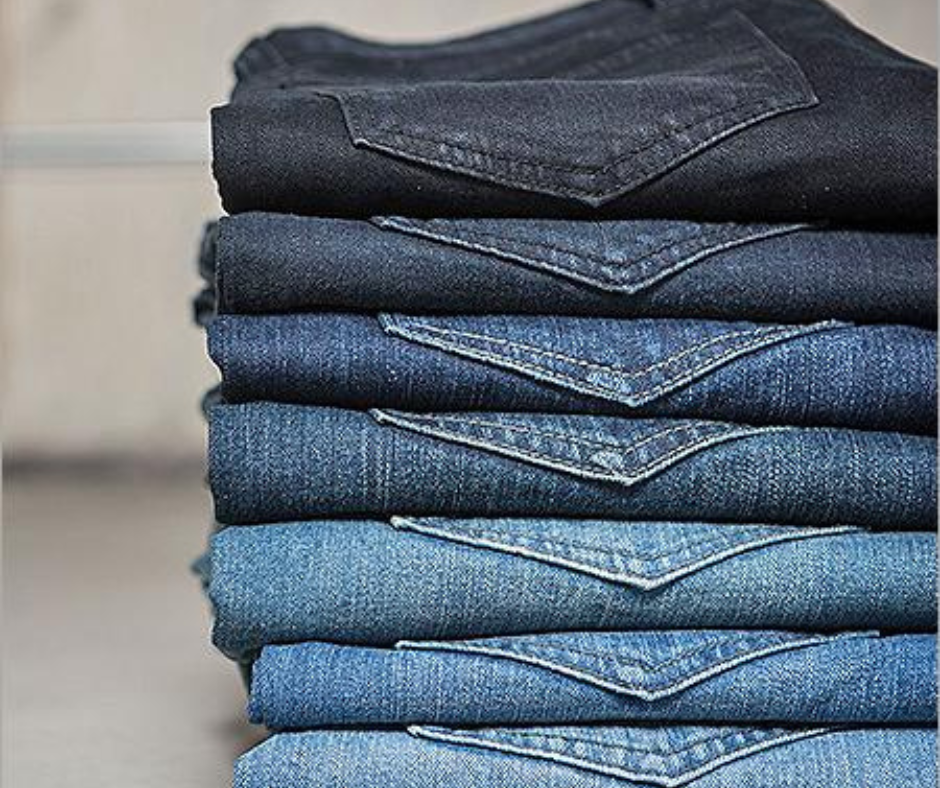 Stack of folded denim jeans in different shades of blue