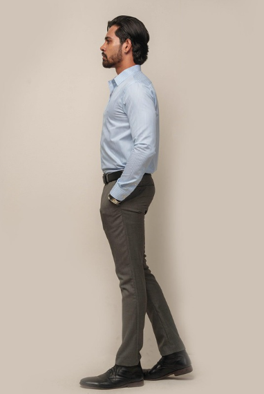 Side view of man wearing light blue formal shirt with trousers and formal shoes